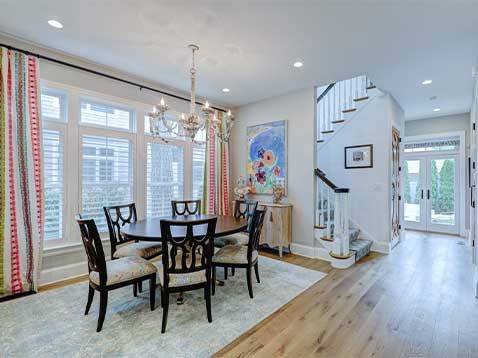 Interior shot of a dining room, stairwell, and foyer
